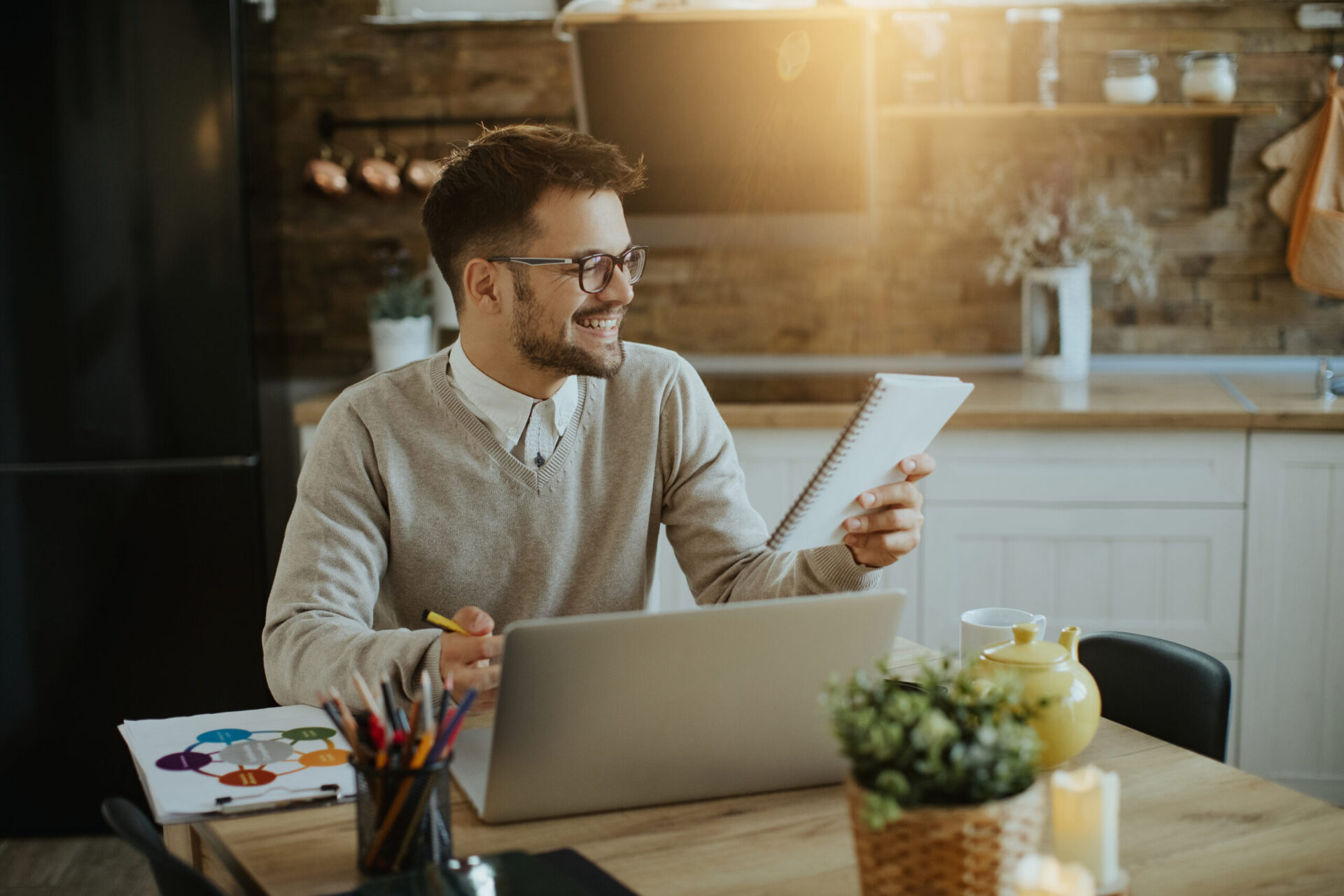Happy Entrepreneur Reading Notes While Working Laptop Home Scaled